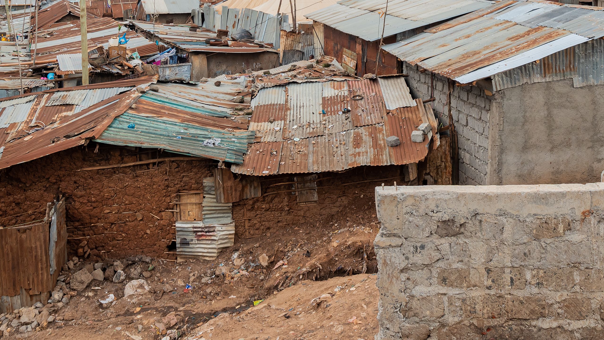 Houses built of crumbling clay brick and rusting corrugated metal in Kibera.