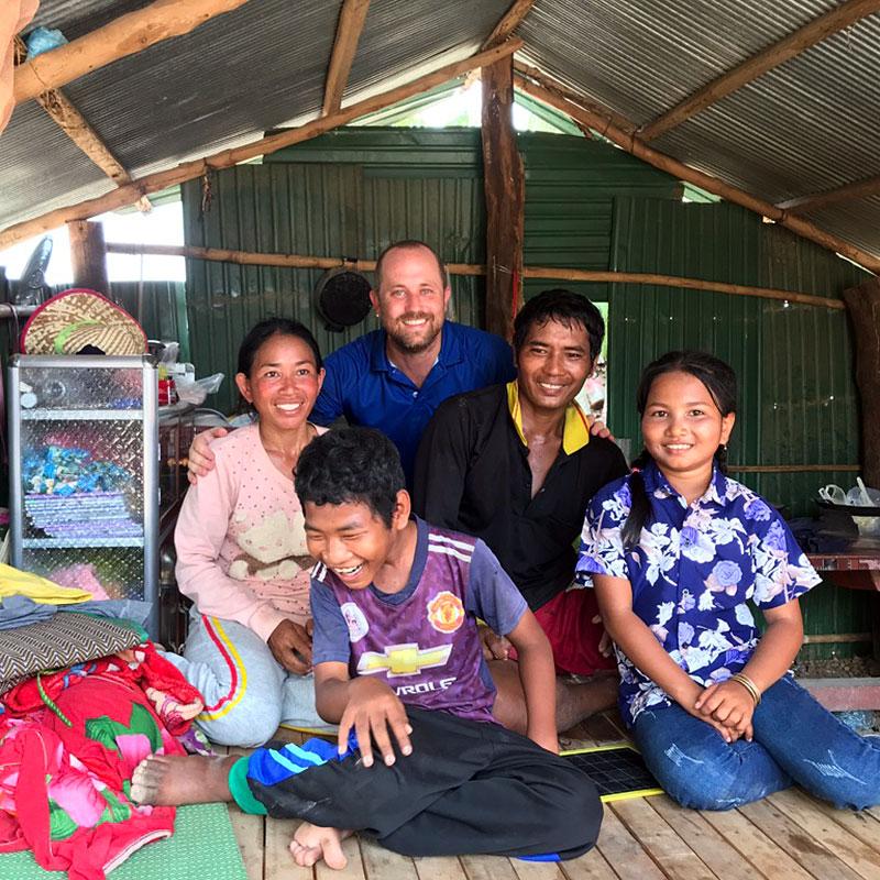 Dan Peyton (back, center) with the Cambodian family whom he worked with to build their new home