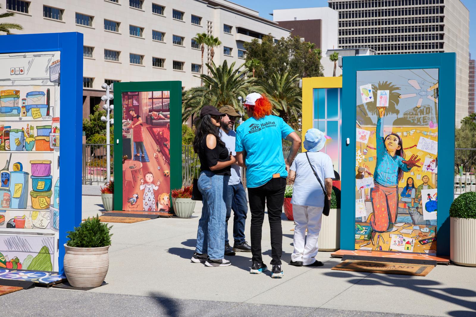 A small group of people viewing a group of the illustrated doors.