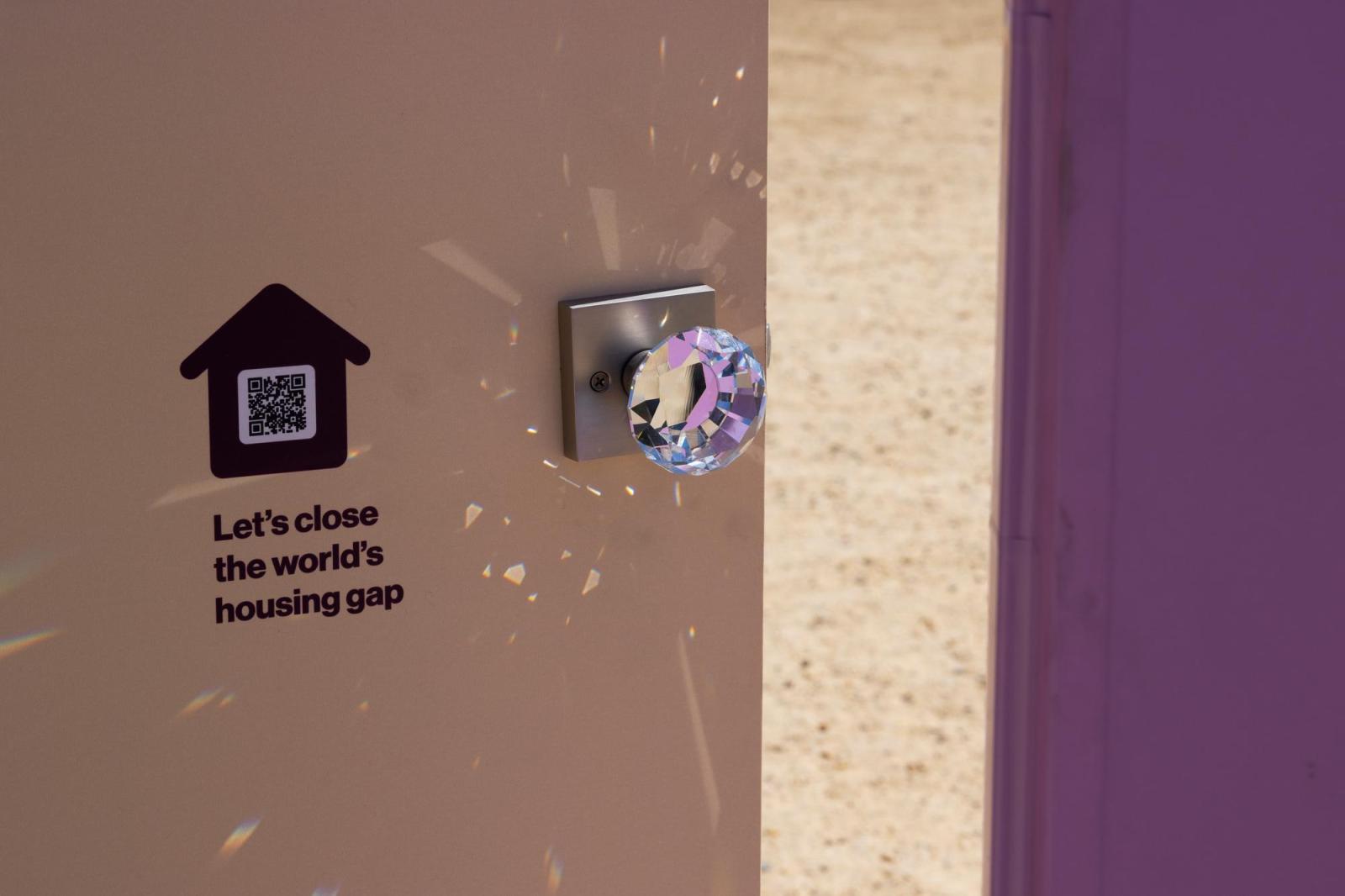 Tan door with Black house QR code.