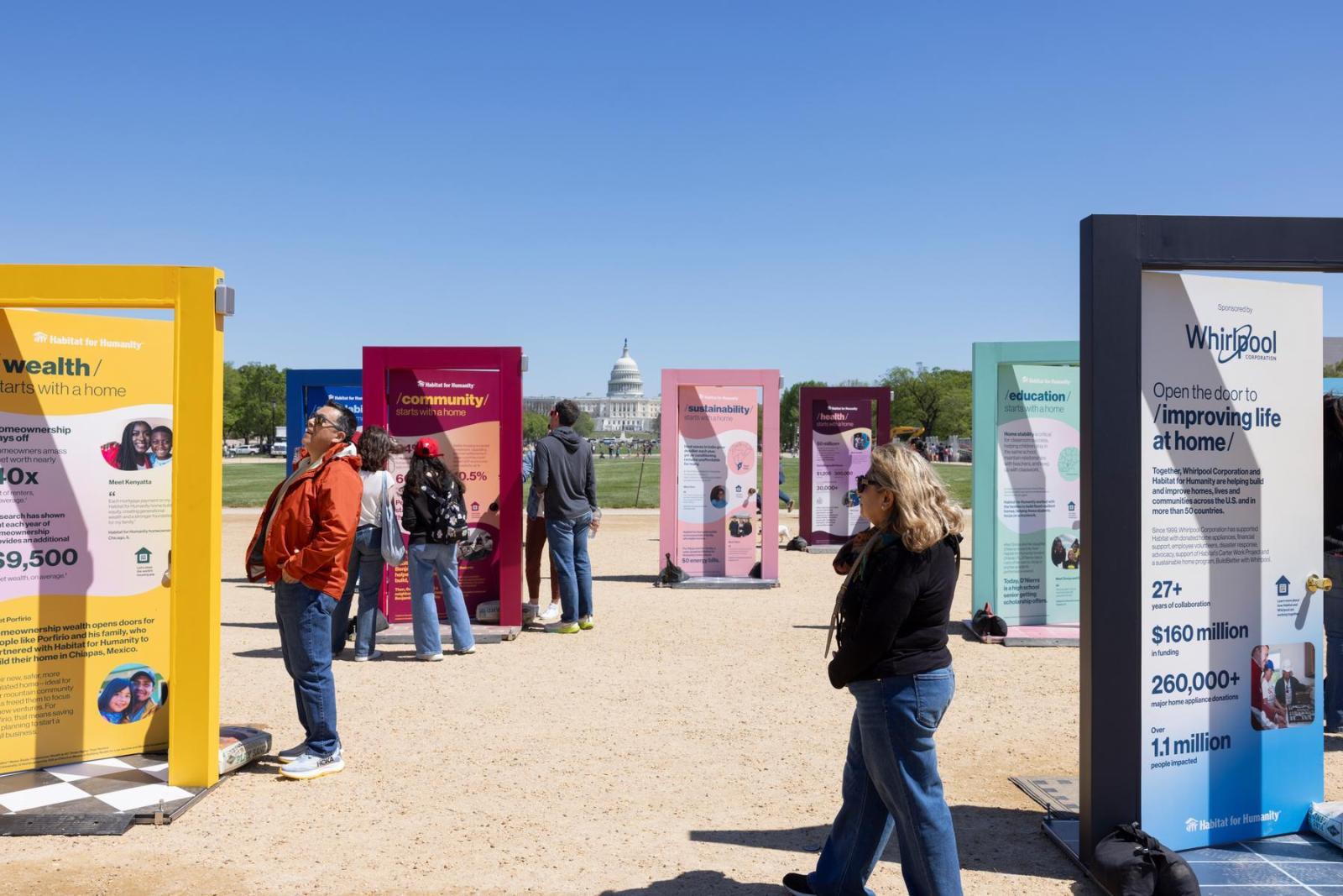 People mill around the pop-up door exhibition that is based in Washington D.C. The Capitol sits in the background.