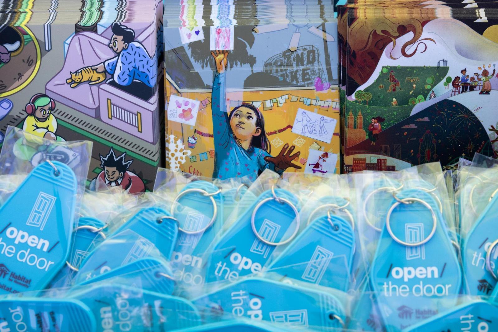 Illustrated images of door art and blue Habitat keychains.