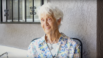 Older adult Rachel sits outside her home that has been updated with the Aging in Place program.