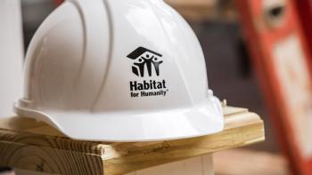 Hard hat sitting on a block of wood.