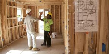 Volunteers high fiving on a build site for Habitat.