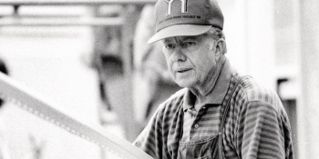 Black and white photo of Jimmy Carter working during the 1988 Carter Work Project.