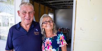 An older couple standing in the doorway.
