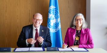 Jonathan Reckford and Anacláudia Rossbach signing letter of intent at WUF13.