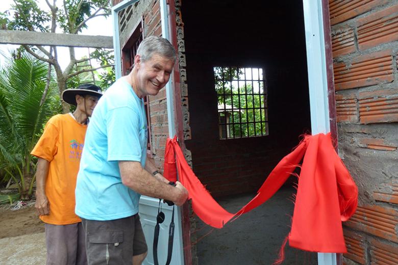 Warren Jack cutting the ribbon at 2023 home dedication in Vietnam